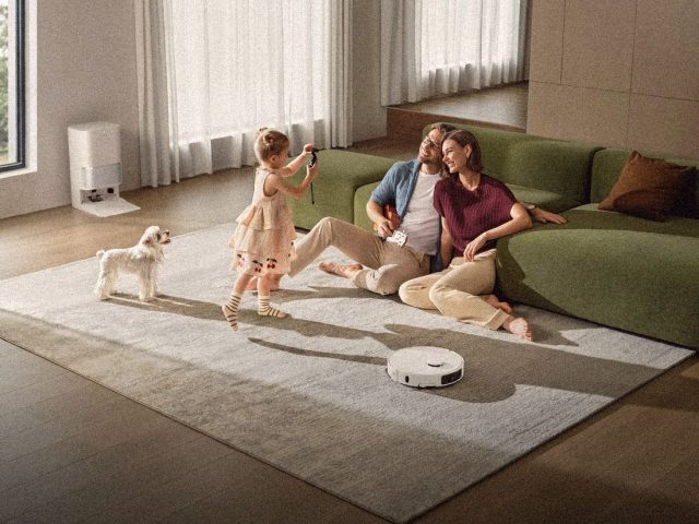Family living room with a home robot at work, 1X NEO review