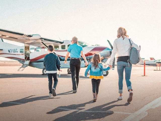 Family walking to a small plane on the apron, Allianz Travel Insurance review