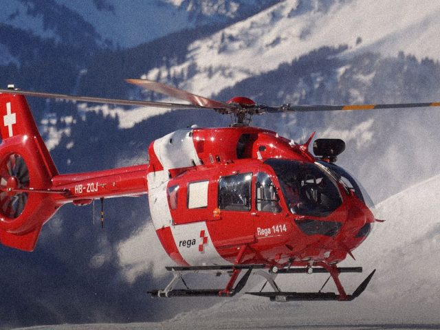 Red rescue helicopter over snowy mountains, best emergency apps