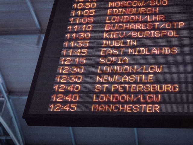 Airport departure board listing UK flights, best flight tracker apps