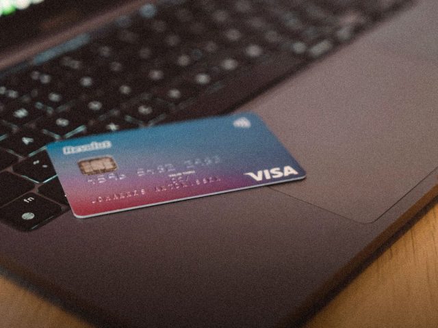 Debit card resting on a laptop keyboard, Chime review