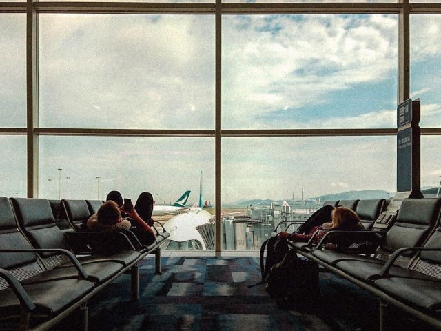 Passengers waiting at an airport gate window, Flighty review