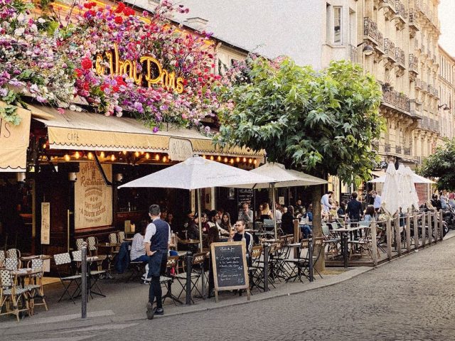 Pavement café on a flower-lined European street, Locals Insider review
