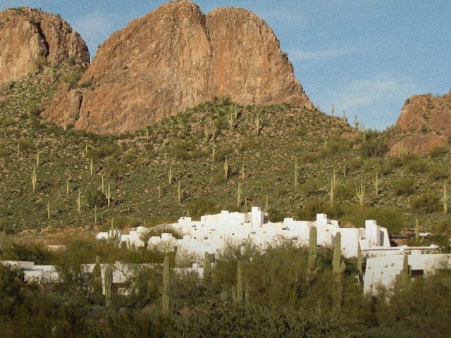 White desert resort below red rock mountains, longevity retreats in the US