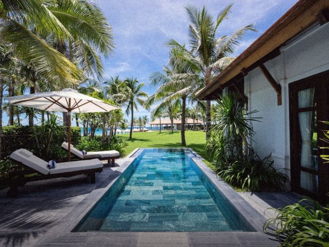 Private villa pool among palms, luxury villa rental agencies