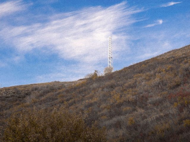 Radio masts on a grassy hillside, Meshtastic off-grid messaging