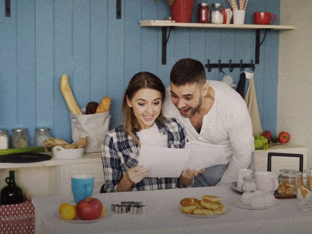 Couple going through papers at the kitchen table, Monarch Money review