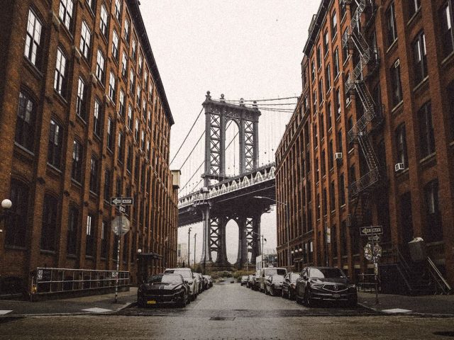 Manhattan Bridge framed by New York brick buildings, SoFi Checking and Savings review