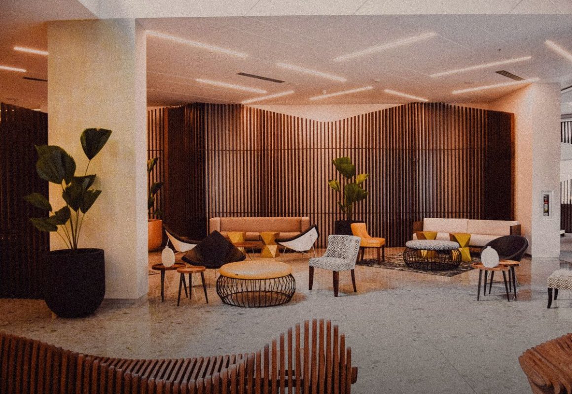 Design hotel lobby with warm wood and plants, Softer Volumes review
