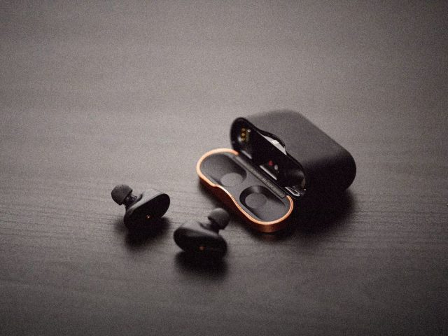 Wireless earbuds beside their charging case, Soundcore Sleep A30 review