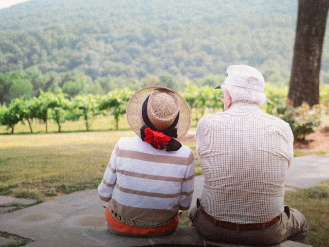 Older couple resting on a viewpoint bench, Staysure review